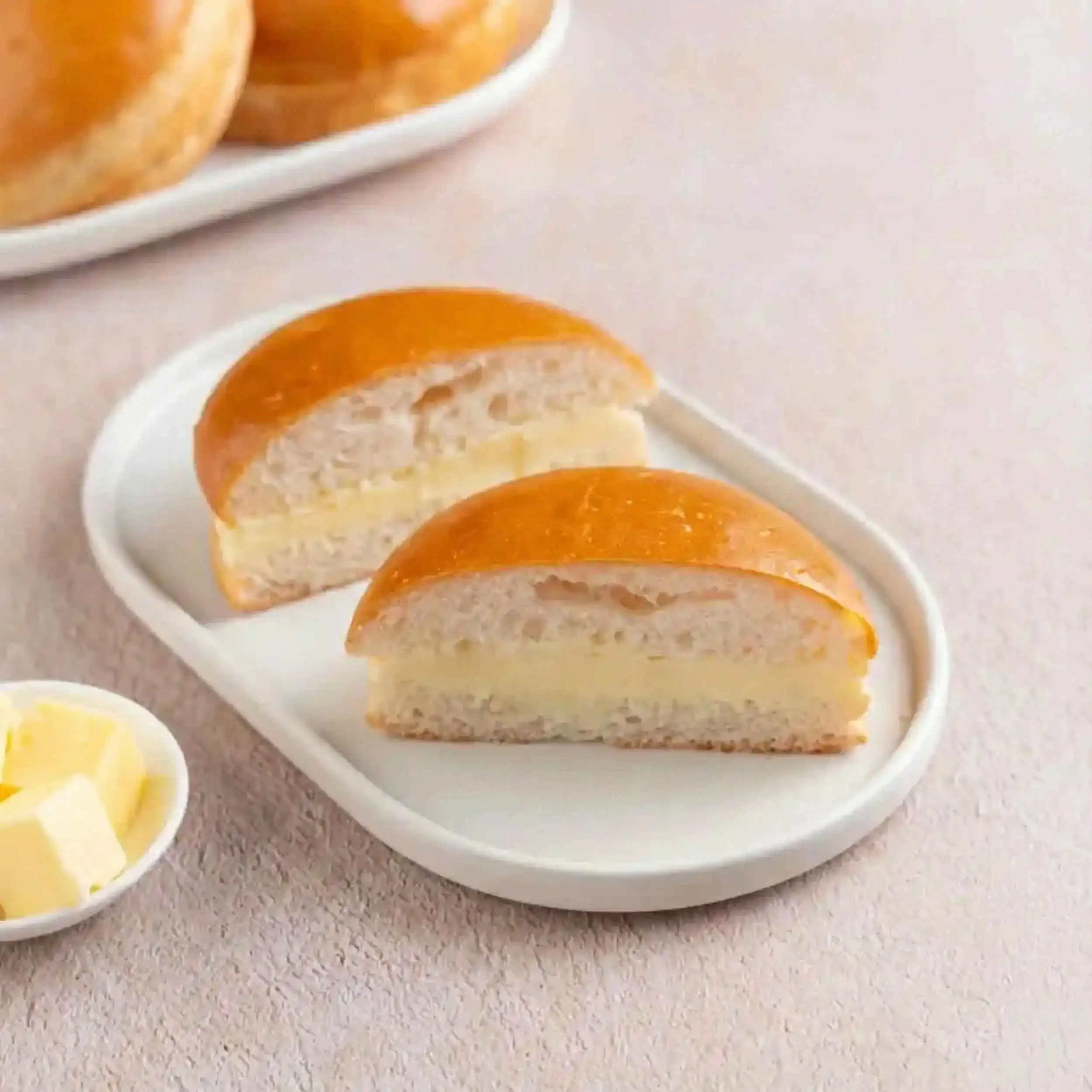 Bun Maska — Soft, warm bun generously spread with creamy butter, offering a simple at Dum N Grill Pearland, Pearland